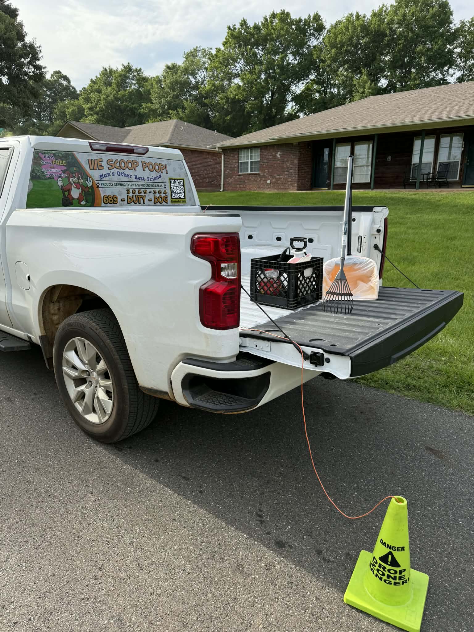 Duty Dog pet waste removal truck parked at a home during pooper scooper service